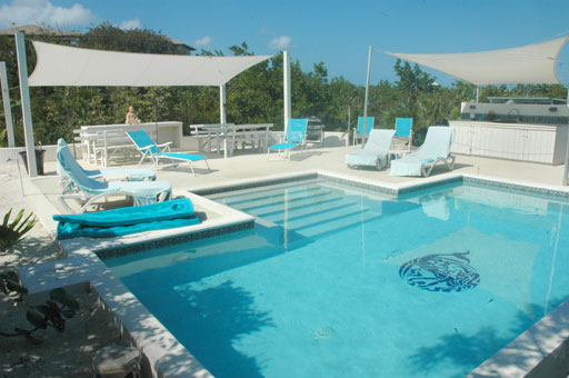 pool_6992.jpg - The pool is 12ft x24ft  and 4ft deep with bench seats along the steps.  The decking and pathways are a first in the Caribbean utilizing a biodegrable, non-toxic product that turns sand into stone, and our pool pump is solar powered.  The jacuzzi is 5ft x 6ft and seats four persons.  There is a wet bar and grill for barbecues and a spacious shaded dining area with bench seat picnic tables and buffet bar.  